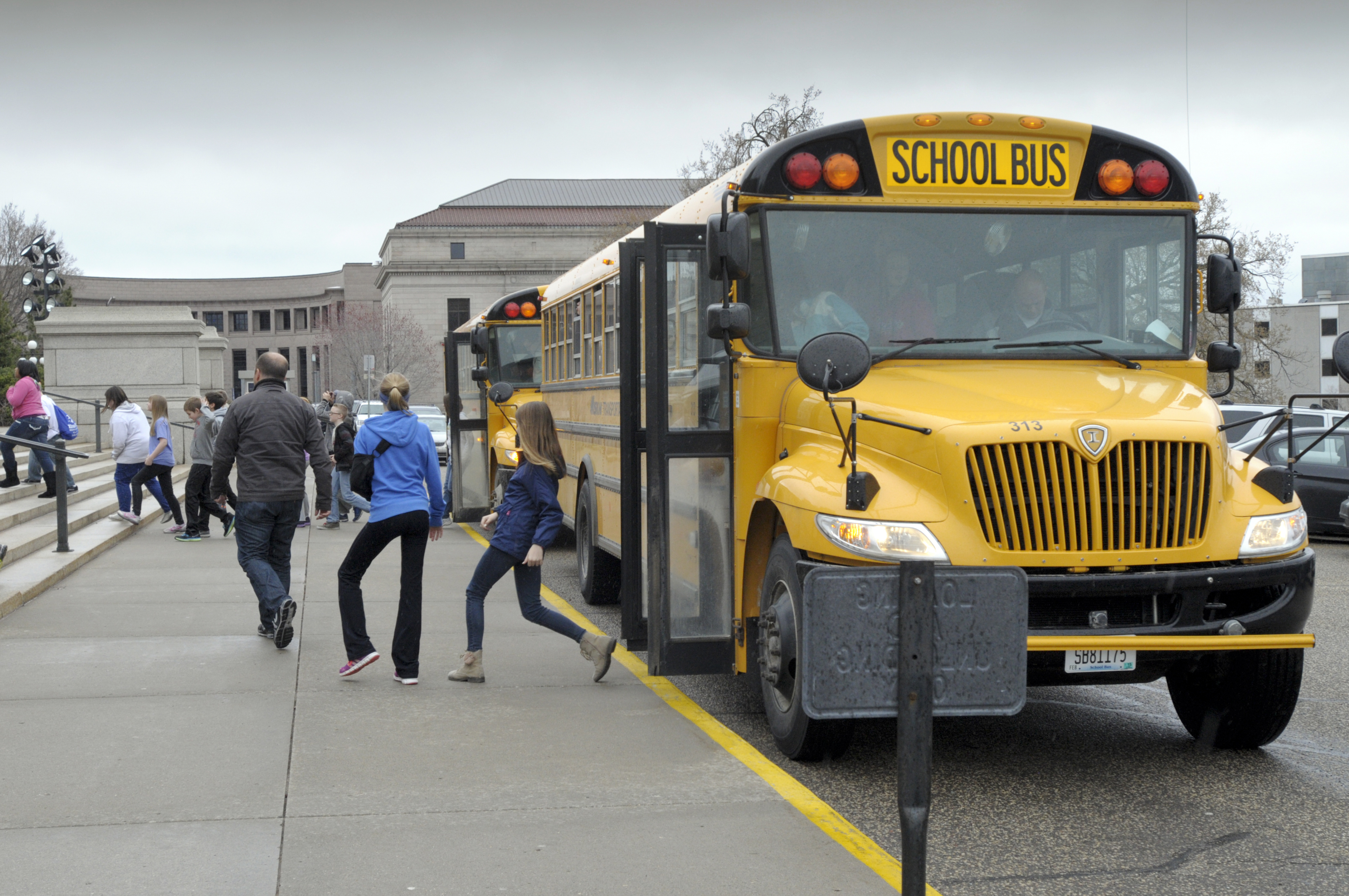 School kids disembark from a bus at the State Capitol. House Photography file photo 